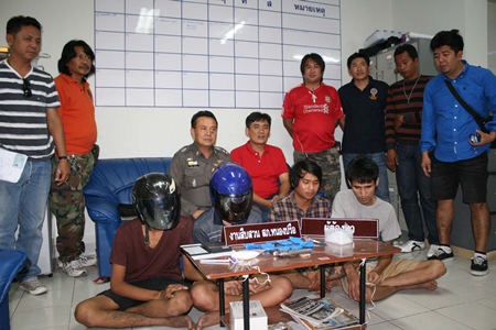 Police bring out the suspects, drugs and weapon to show the press.